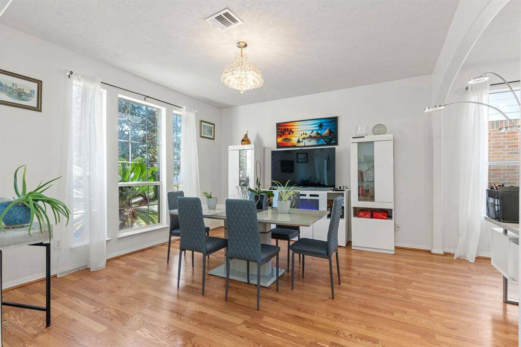 Gorgeous wood floors highlight the formal living or dining area, adding warmth and elegance!