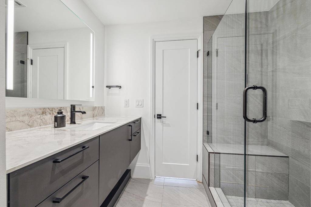Primary bathroom with Eggersmann cabinets, walk-in shower.