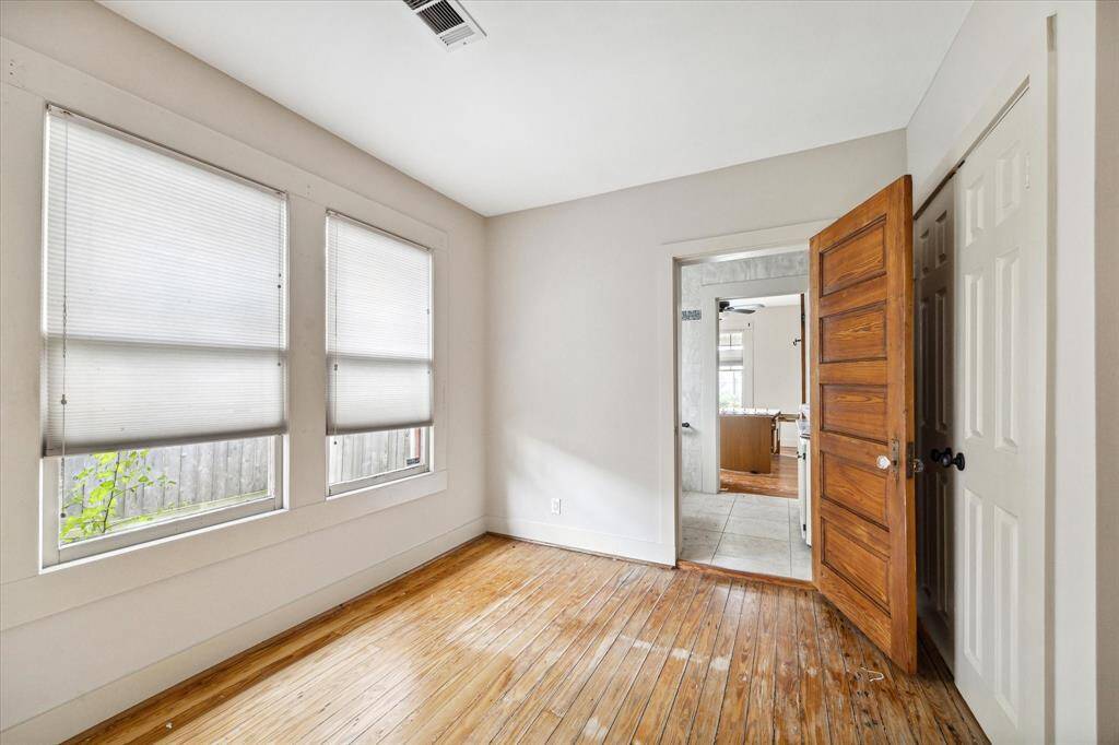 Secondary bedroom with shared bathroom featuring double sink vanity. Utility closet behind double doors.