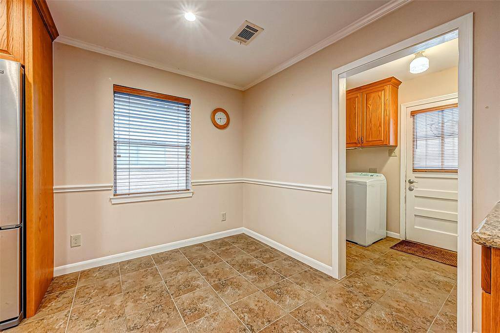 Seamlessly transitioning from the kitchen to the utility room, this nook provides both functionality and convenience, making it an ideal spot for gathering, dining, or even setting up a small workstation.