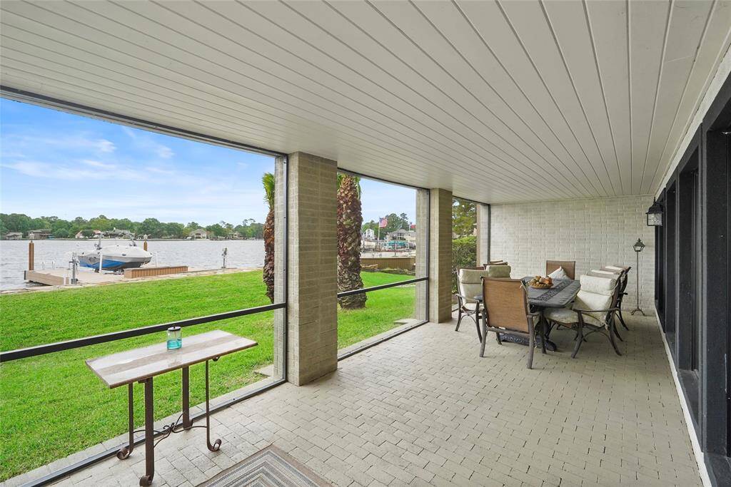 1st floor screened patio with remote lift screen for pool access
