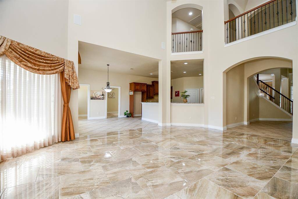 The open den features tile floors and very high ceilings!