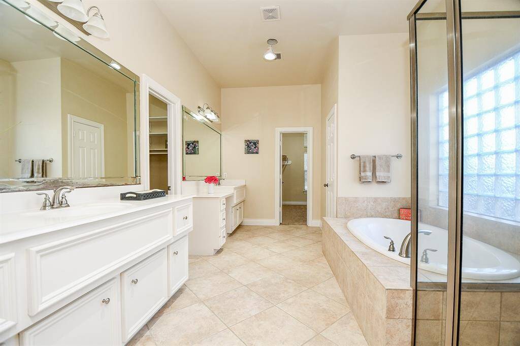 The primary bathroom features a tiled bathtub with a separate standing shower!