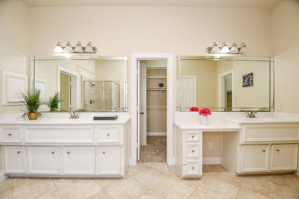 Two separate vanities and two walk-in closets in the primary bathroom!
