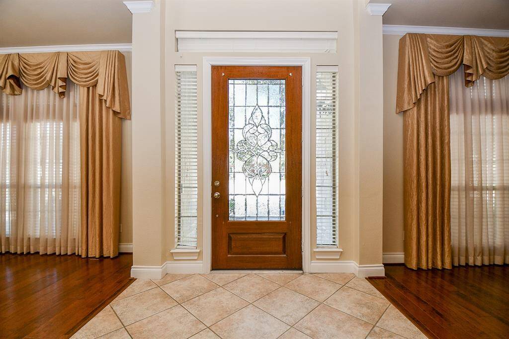 Once inside the grand entrance greets you with high ceilings and elegant tile floors!