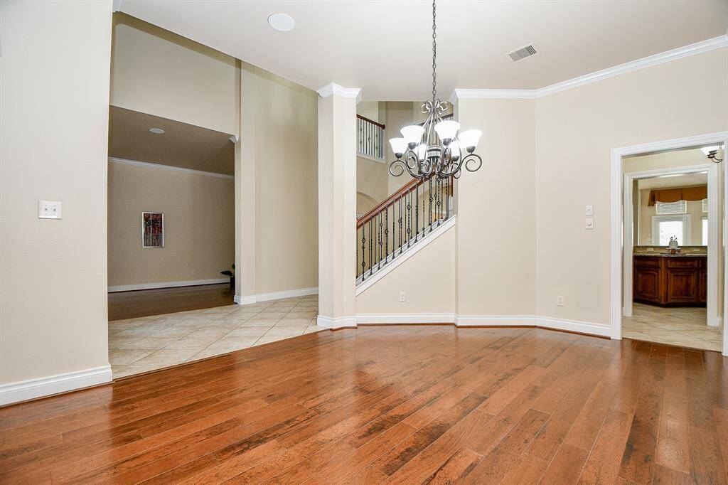 To the right, the formal dining features hard wood floors and a low hanging chandelier!