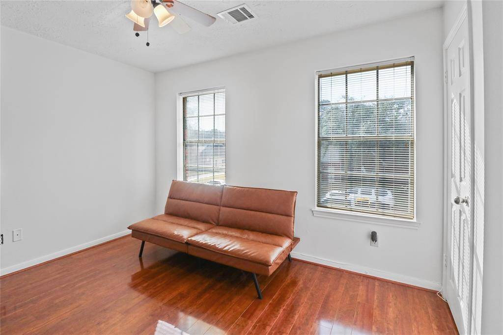 Bright and versatile fourth bedroom with abundant natural light, perfect for a guest room or home office.