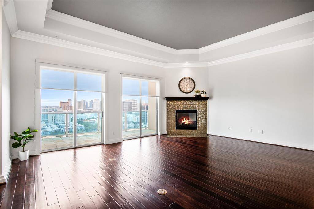 On the left is the small foyer with a beautiful light fixture. To your right is the formal dining room with an elegant chandelier.