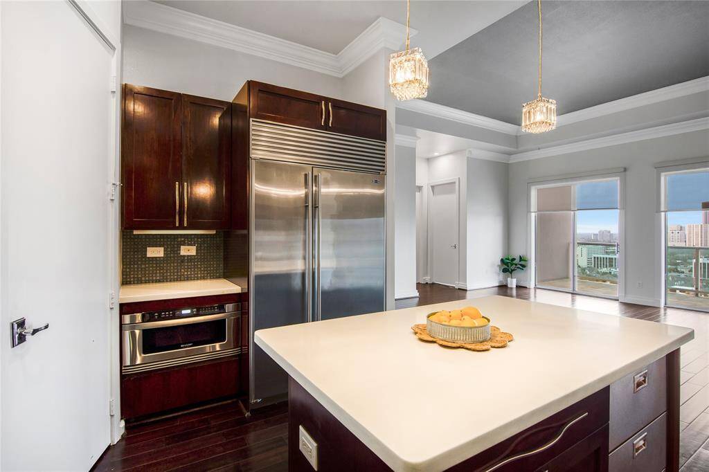 The primary bedroom with a gorgeous chandelier also has an abundance of natural light and you also get the amazing view!