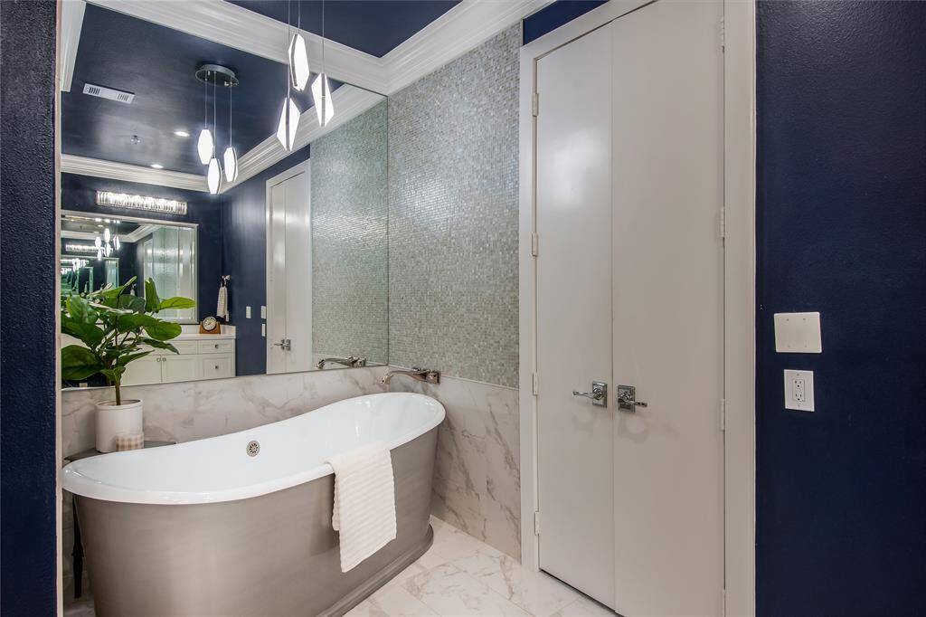 En suite bathroom in the secondary bedroom has a large vanity, lots of storage and a beautiful large walk-in shower.