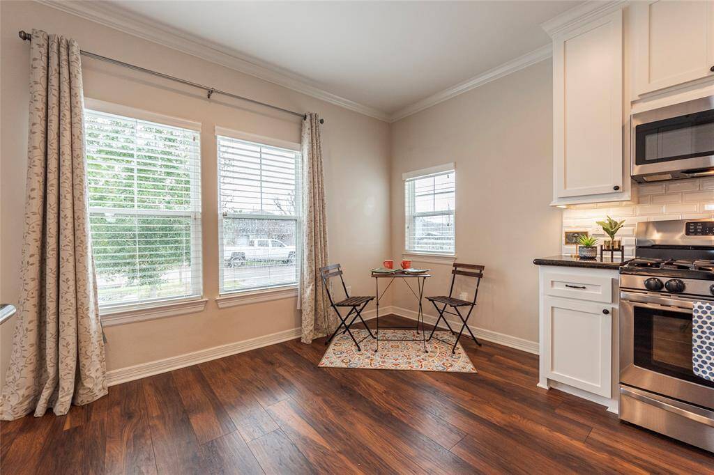 Enjoy meals in this charming dining area just off the kitchen, where large windows fill the space with beautiful natural light.