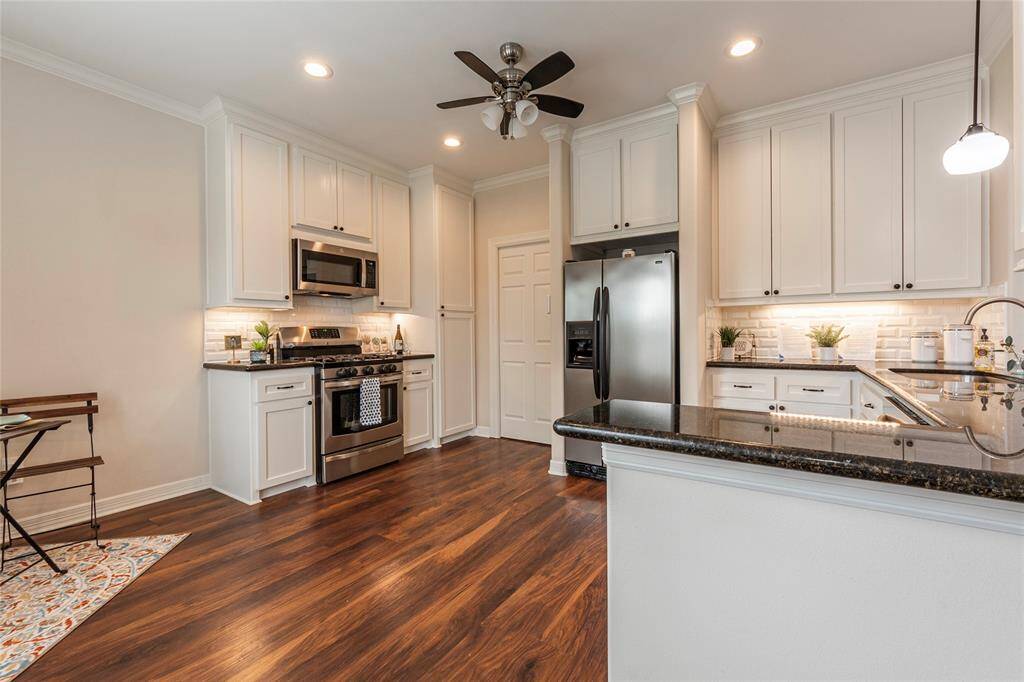 Spacious kitchen featuring granite countertops and ample lighting