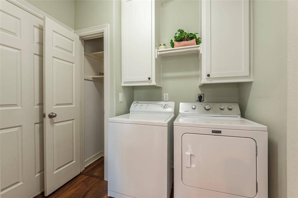 Conveniently tucked behind a pocket door off the kitchen, with direct access to the garage. Includes a washer and dryer that convey with the home.