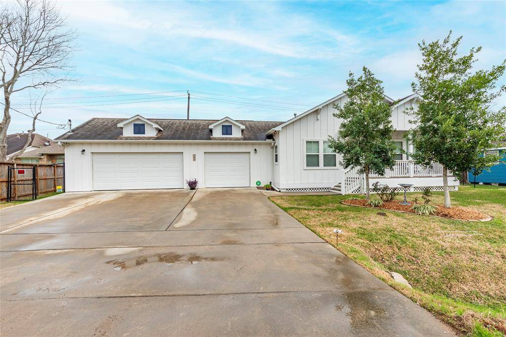 Expansive 750 sq. ft. 3-car garage with ample storage space, perfect for vehicles, watercraft, or hobbies.