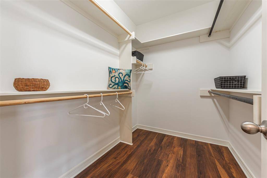 Huge walk-in closet with tons of storage and built-in shelving for optimal organization.