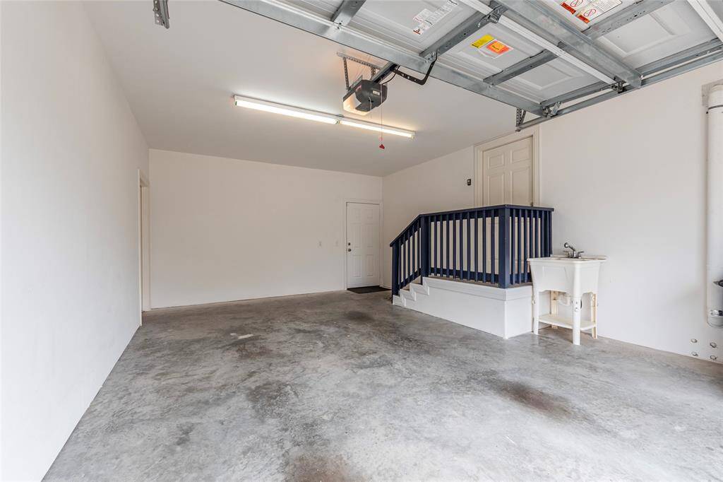 Single car garage with interior access to home. This side of the garage comes equipped with a utility sink.