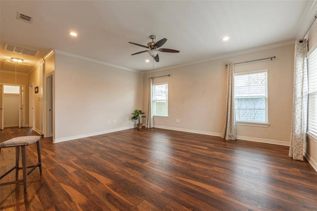 Step into this bright and airy living room, where large windows flood the space with natural light, creating a warm and inviting atmosphere.