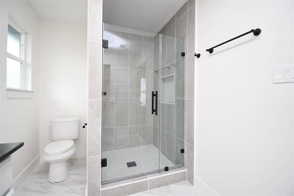 Separate walk-in shower with seamless glass door! Pretty hardware!