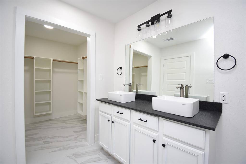 Spacious primary bathroom with amazing counters and storage!