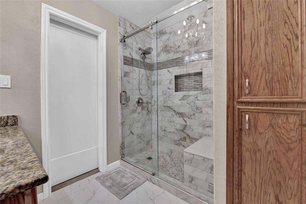 Recently updated walk in shower in primary bathroom
