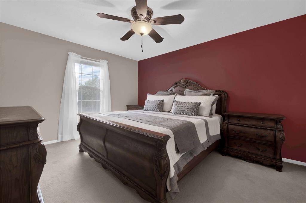 Upstairs guest bedroom with large closet and access to extra storage room