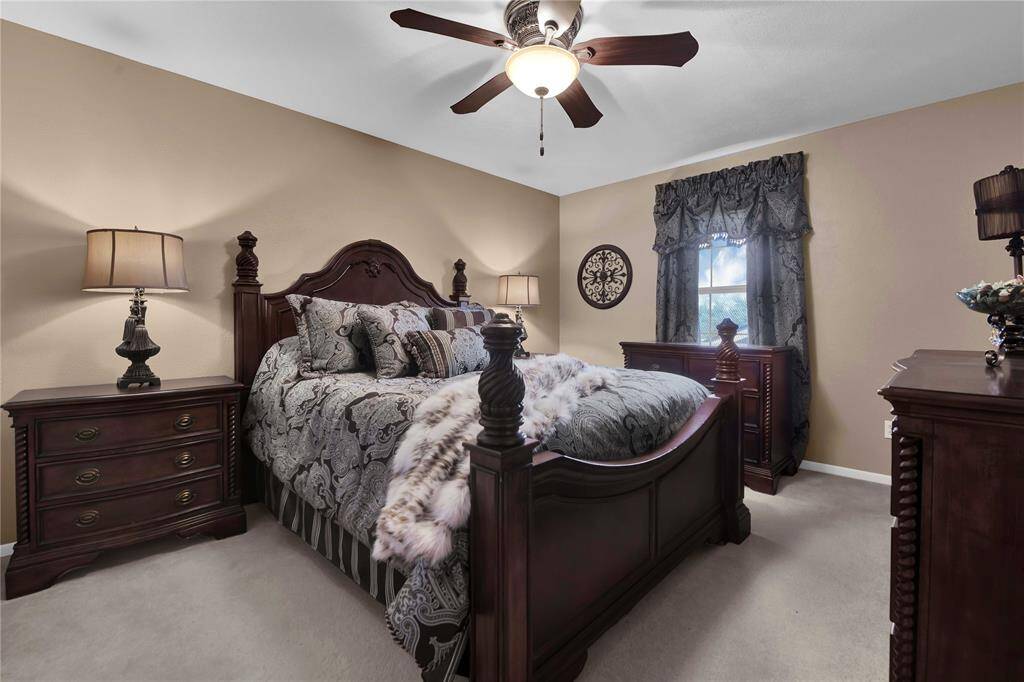 Upstairs guest bedroom with large closets and access to extra storage room