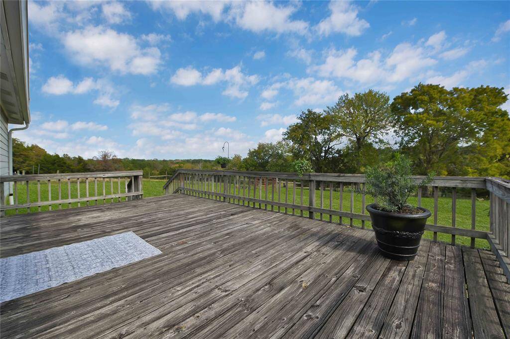 Pictured deck was removed and single staircase has been installed.