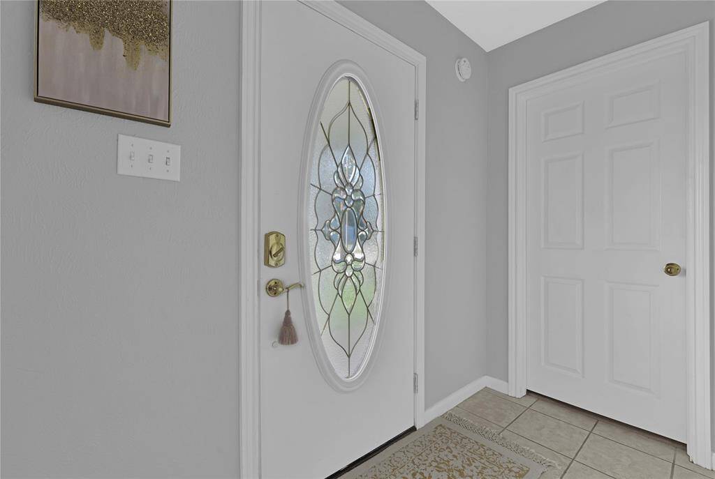 Front door and entrance into primary bedroom