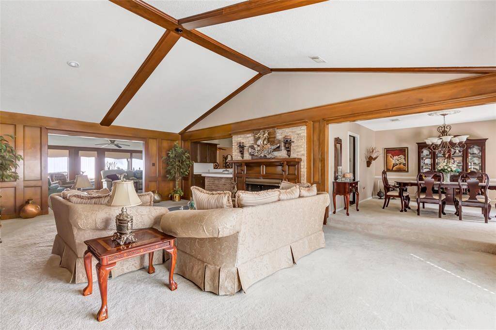 Formal living opens to formal dining and den area that overlooks the back yard...