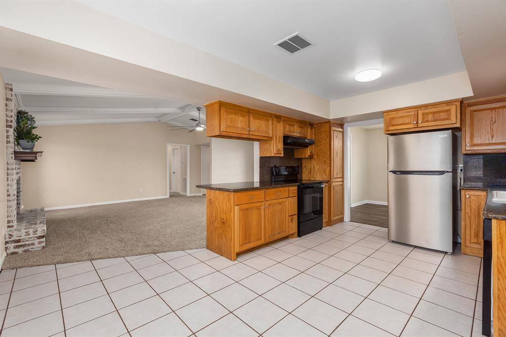 Spacious kitchen with a seamless view into the living area. Convenient pantry located next to the range.