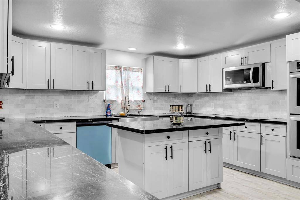 Fully remodeled with expansive counter space and modern finishes, ideal for entertaining.