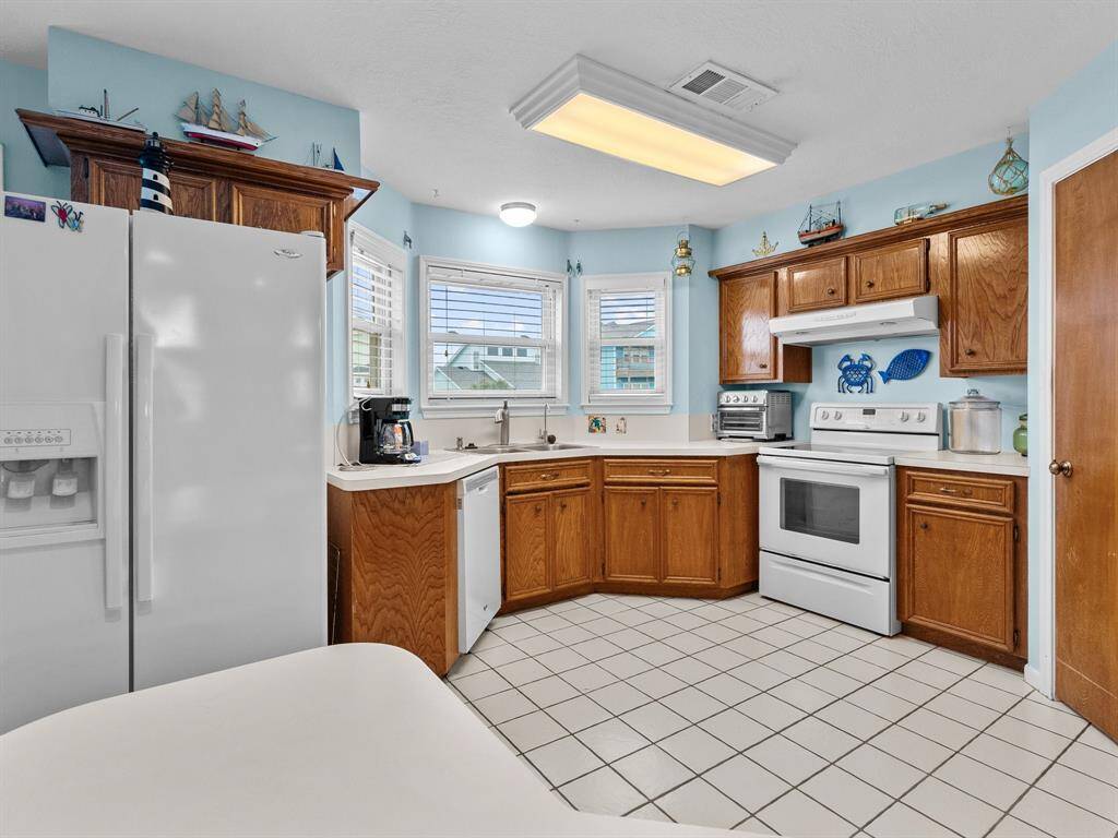 Kitchen has views out to the back deck and canal.