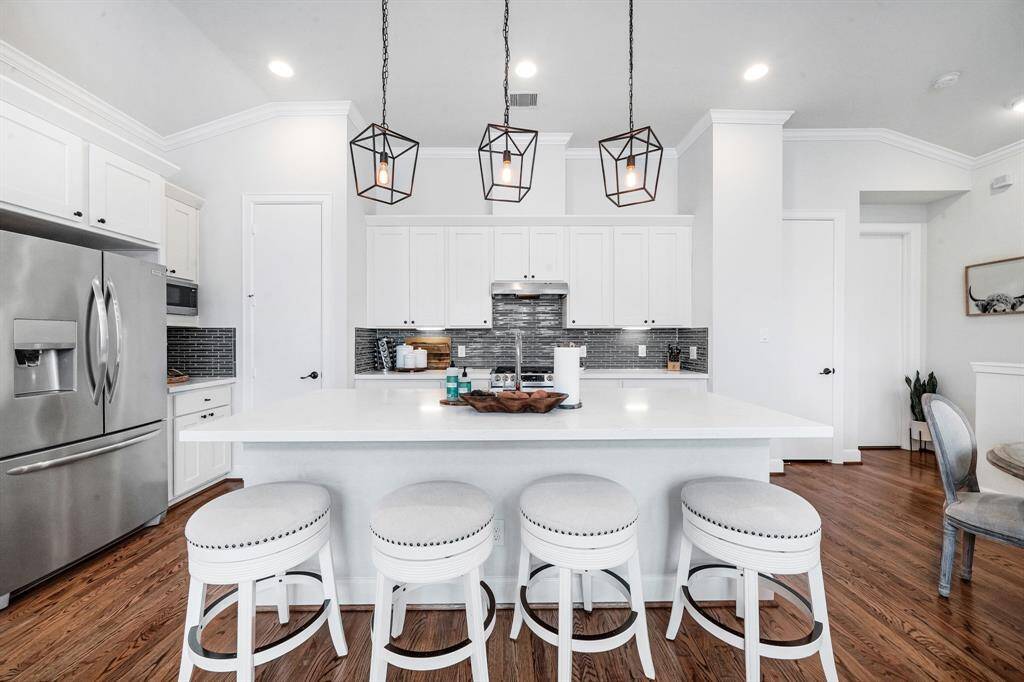 Clean with modern finish kitchen with large breakfast bar island.