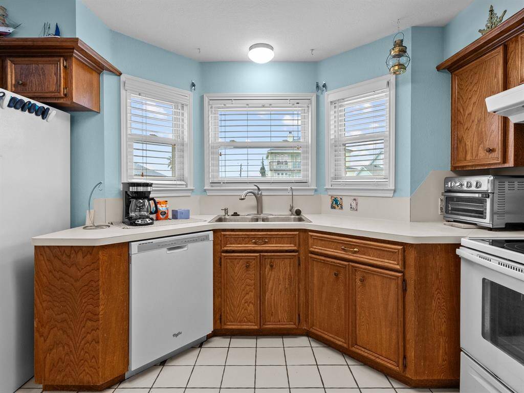 The sink has views out to the water and boat house.