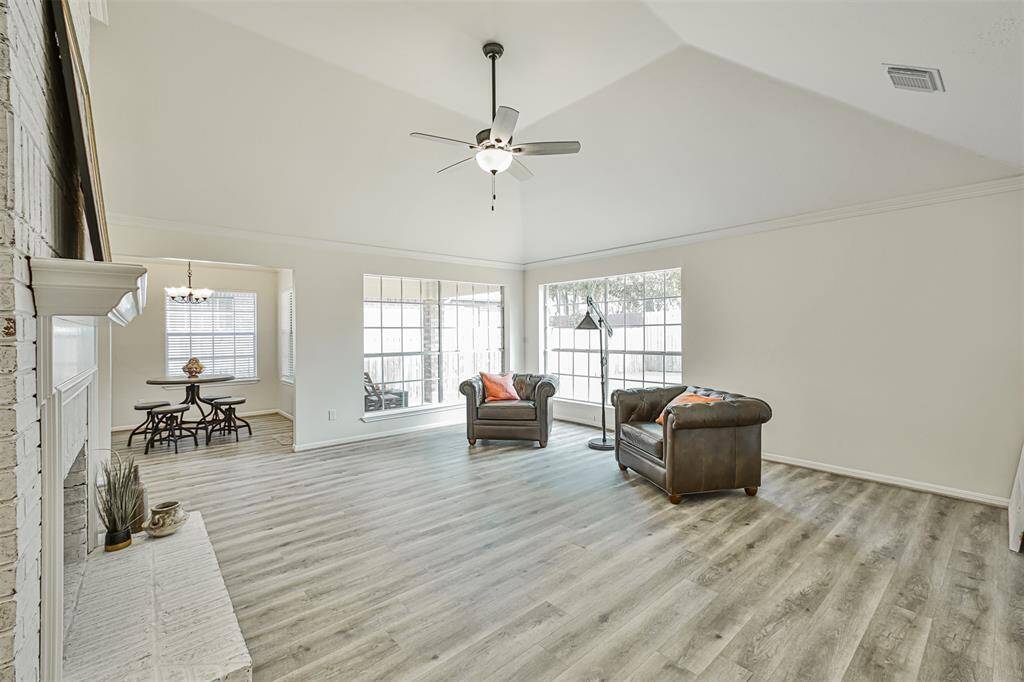 The formal living room boasts with high ceilings, brick fireplace, and two grandiose windows. We just hope you have enough furniture to fill up this space.