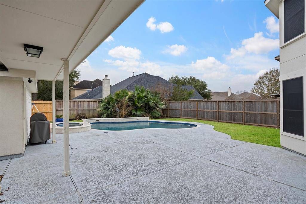 Open outdoor space leading to garage and pool