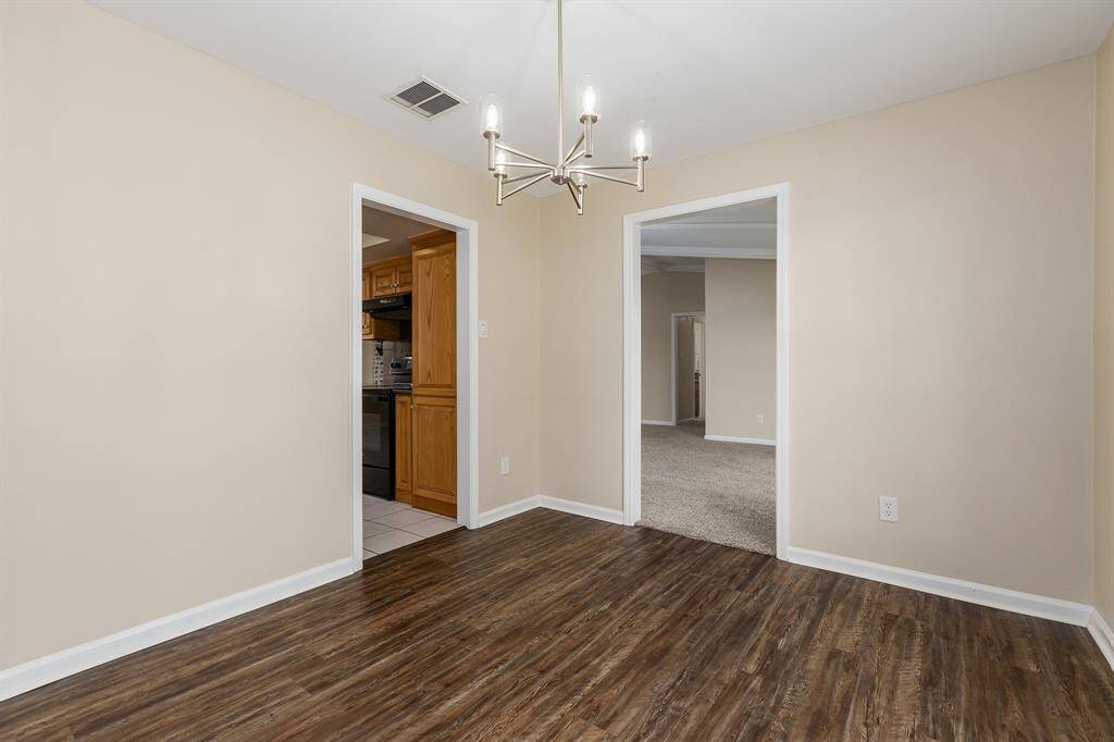 The dining room seamlessly connects to the kitchen on the left and the living area on the right, offering a perfect flow for entertaining.