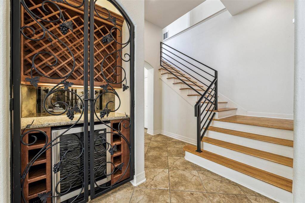 The gated wine grotto has a beverage refrigerator