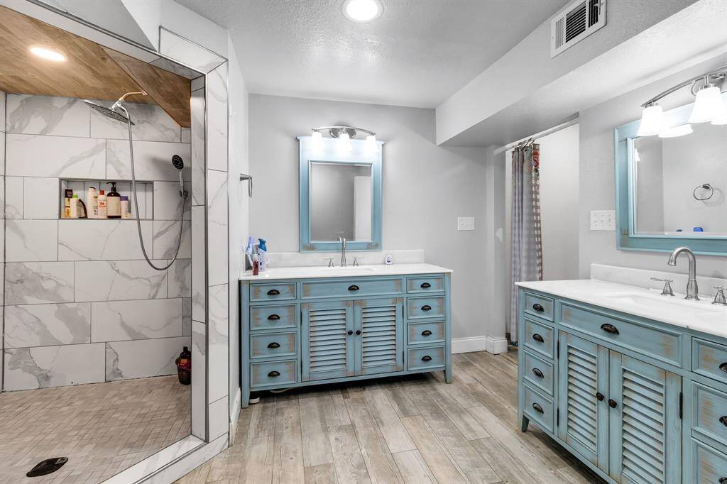 Spa-like with a walk-in shower, separate tub, and dual vanities.