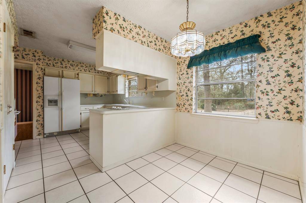 The kitchen features an electric cooktop and offers a blank canvas, ready for the new owners to bring their vision to life with updates and personal touches.