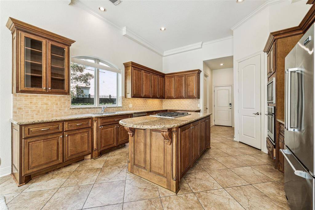 Chef's kitchen with undercabinet lighting and a large walk-in pantry
