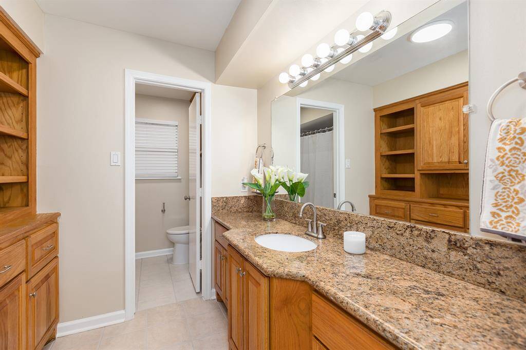 Hall bath features a separate toilet and shower for added privacy.