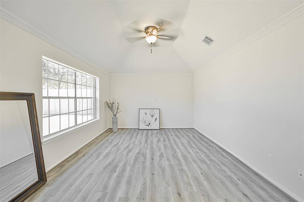 The luxurious master retreat has a high ceiling, oversized window, and plenty of room for your king-size bedroom furniture.