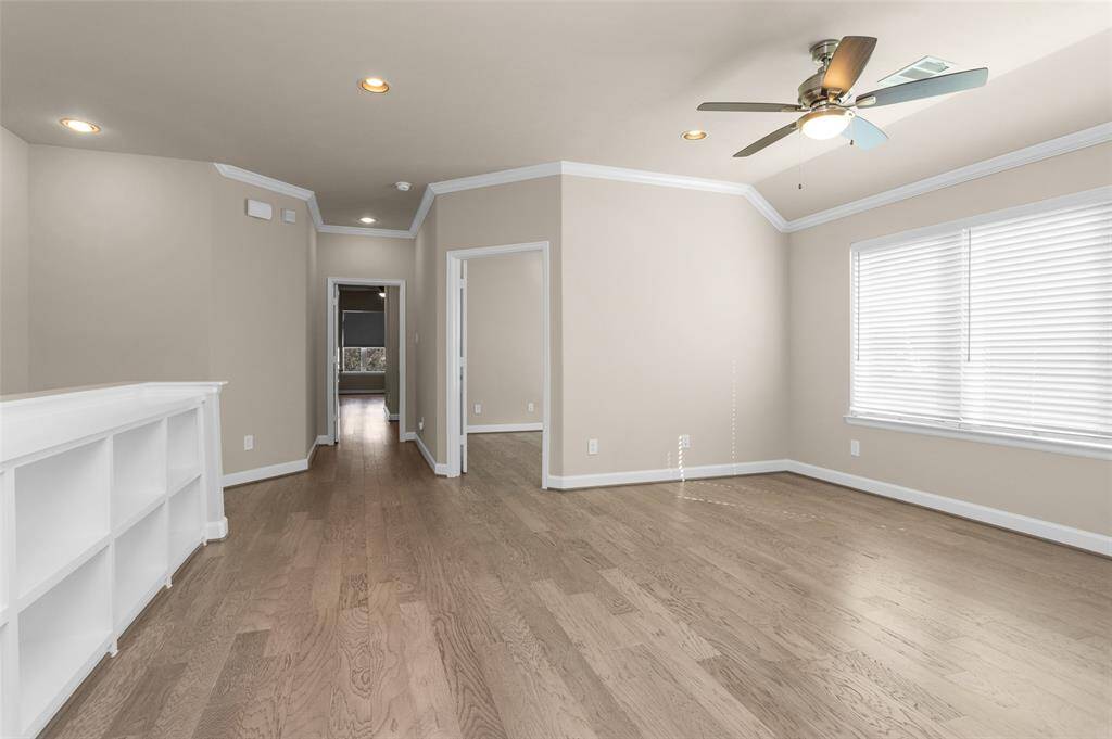 This view is looking towards the office and primary suite. note that hard surfaces are present in the entire home.