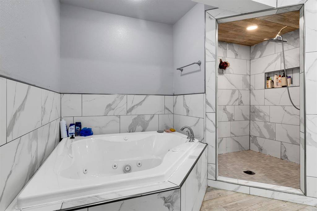 Spa-like with a walk-in shower, separate tub, and dual vanities.