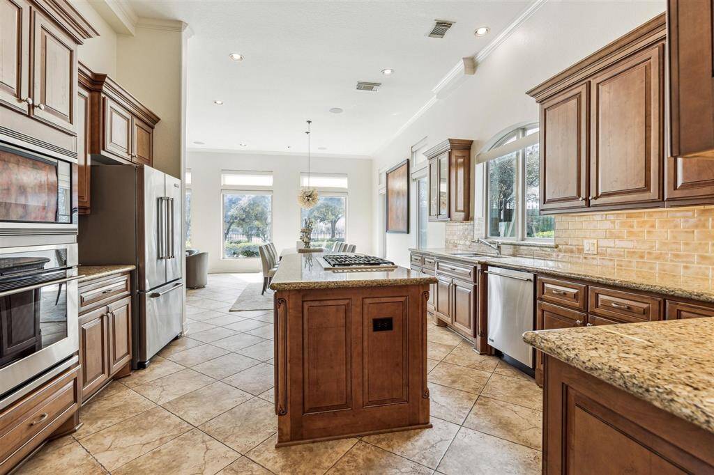 The chef's kitchen has sweeping views of the backyard retreat and golf course.