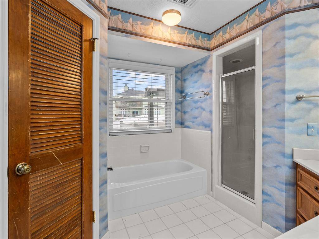 Primary bath with stand up shower and tub.