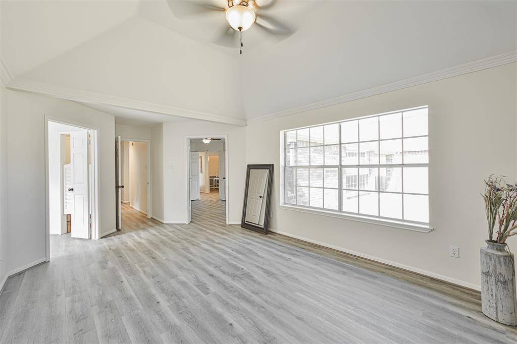 Another view of the primary bedroom. The door to the left leads to a spa-like bathroom. The middle door connects with the hallway leading to kids' bedrooms. The door to the right will take you to bedroom 3/study.