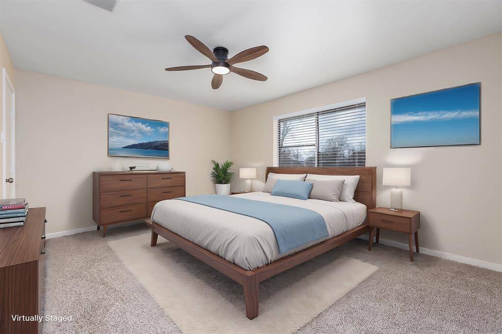 Spacious master bedroom featuring modern decor, abundant natural light, and a relaxing atmosphere.