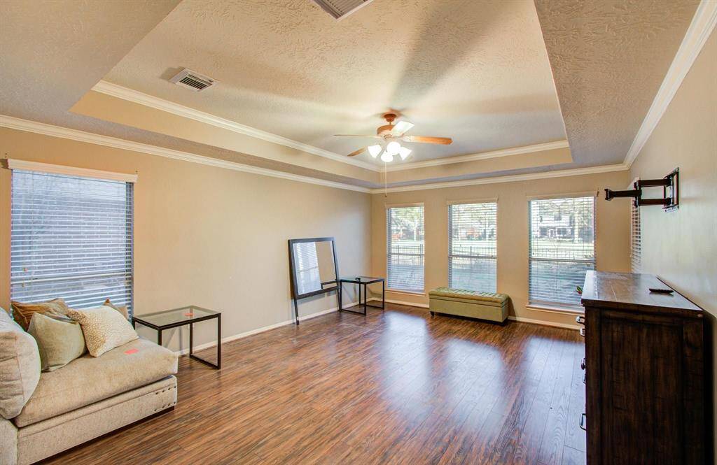 One of the key features of this home is the 1st floor super spacious primary bedroom with a trayed ceiling, wall of windows, good natural lighting and ceiling fan with lights.